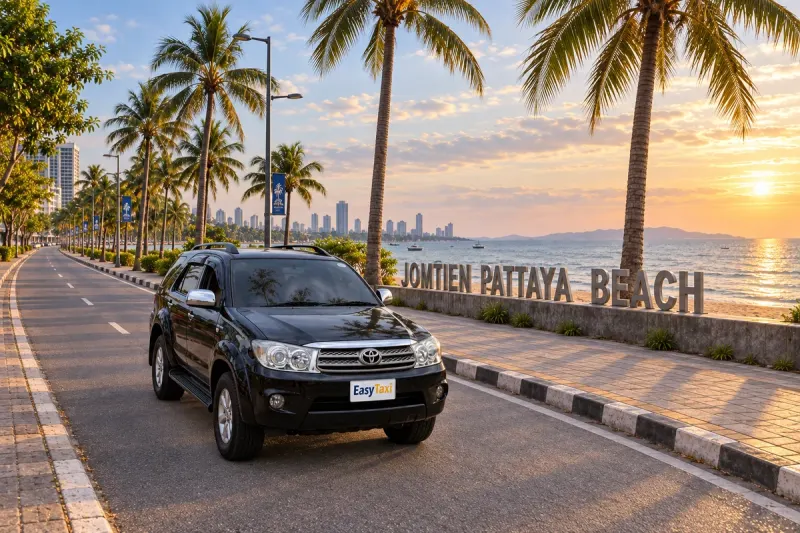 Black Bangkok Pattaya Taxi Toyota Fortuner on Jomtien Beach Road beside the Jomtien Pattaya Beach sign