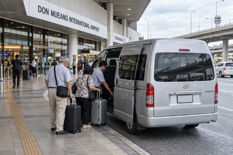 Travellers loading bags into a private passenger van at Don Mueang Airport